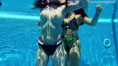 Play Lesbian babes with big tits swim underwater in the pool